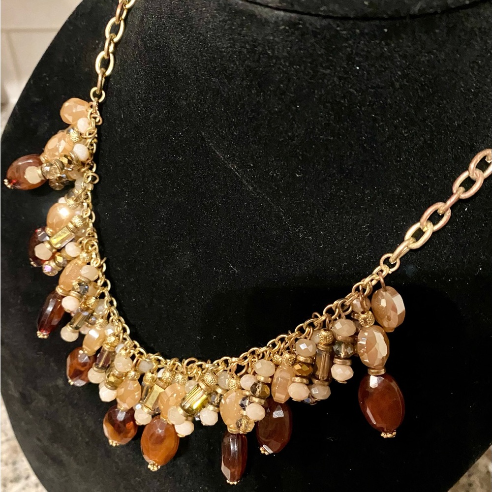 C1946 Brown, clear and gold beaded necklace on gold color chain.